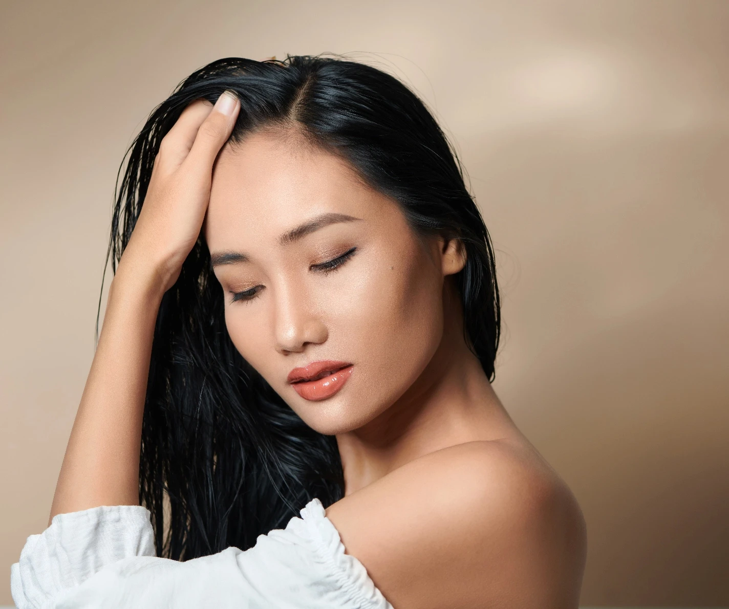 asian woman brushing her hair | Cohn Plastic Surgery Long Island